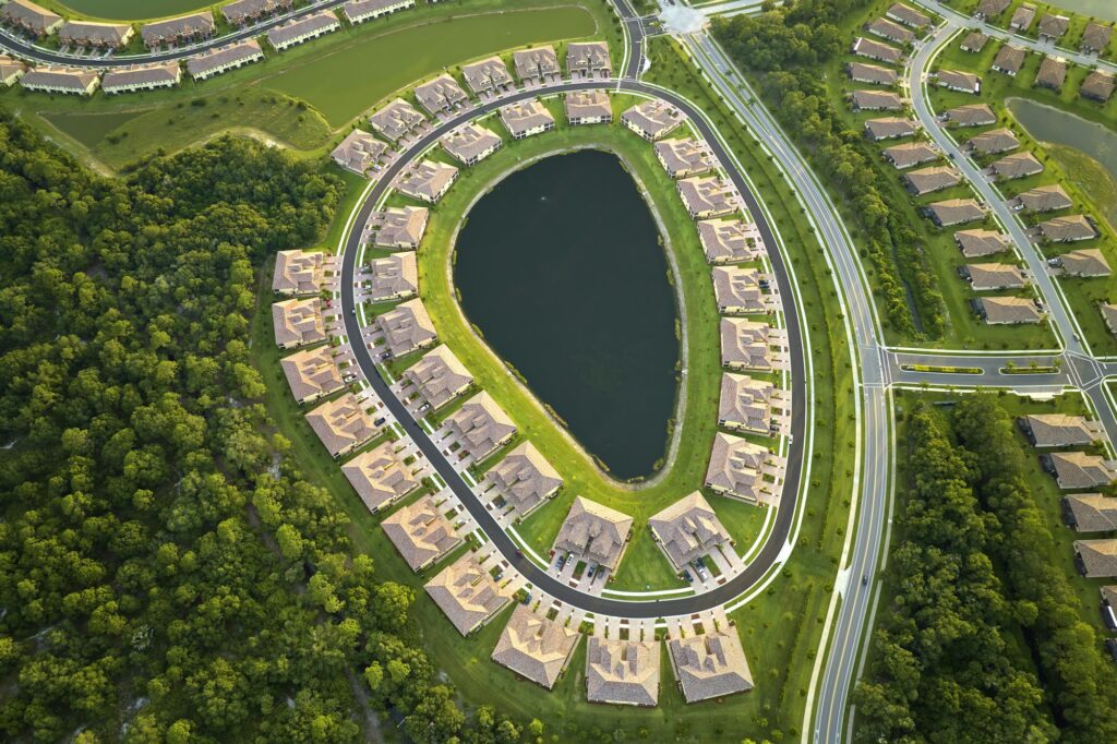 Aerial view of tightly located family houses with retention ponds