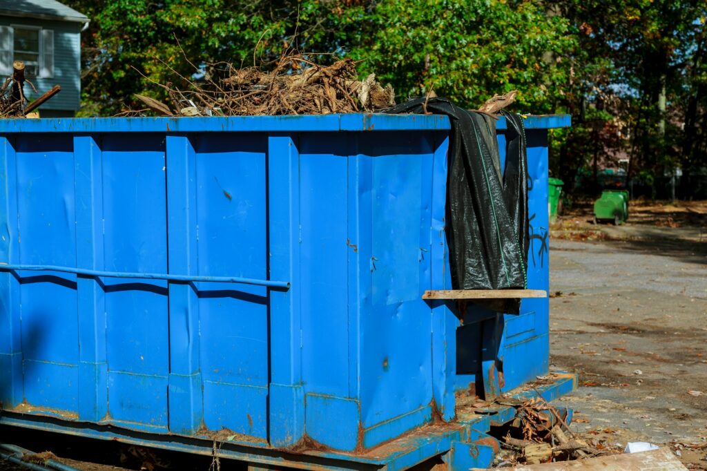 Dumpsters being full with garbage in a city. Dumpsters being full with garbage